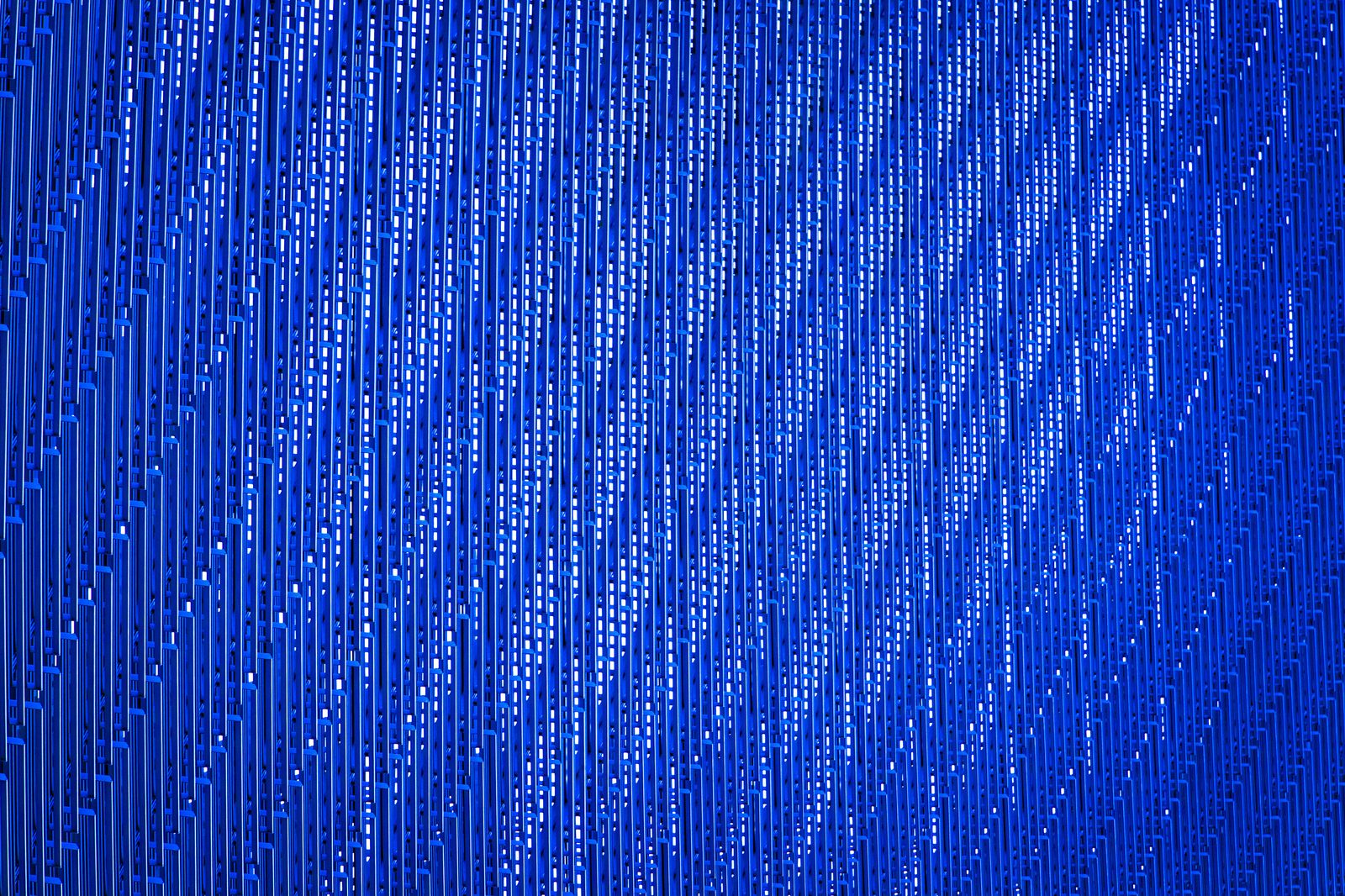 Close-up of illuminated blue perforated panels